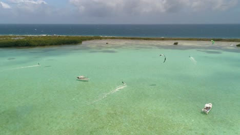 Drohnenaufnahme-Meer-Und-Natur-Umgeben-Vier-Männer-Kiteboard-Karibisches-Meer,-Salinas-Los-Roques