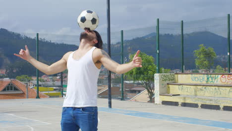 handsome man practicing soccer tricks