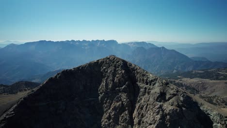 a drone moves around the peak of mountain smolikas in greece