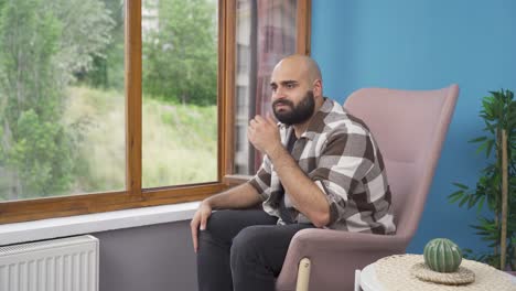 Depressed-man.-The-man-is-watching-out-the-window.