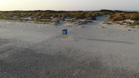 aerial, orbit, drone shot, around a lifeguard post, at a beach, on a sunny evening, in langeoog, germany