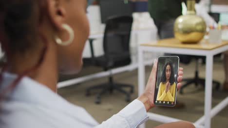 African-american-businesswoman-using-smartphone-for-video-call-with-biracial-business-colleague