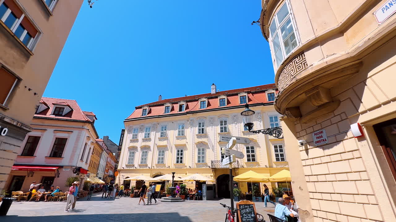 Bratislava, Slovakia, 2 June 2025: Bratislava's lively streets. Visitors enjoy sunny weather and cafes while strolling through Bratislava's lively historic center
