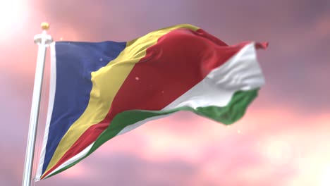 bandera de las seychelles agitando el viento en lento al atardecer, bucle