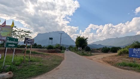 progression of a rural road into a mountainous area