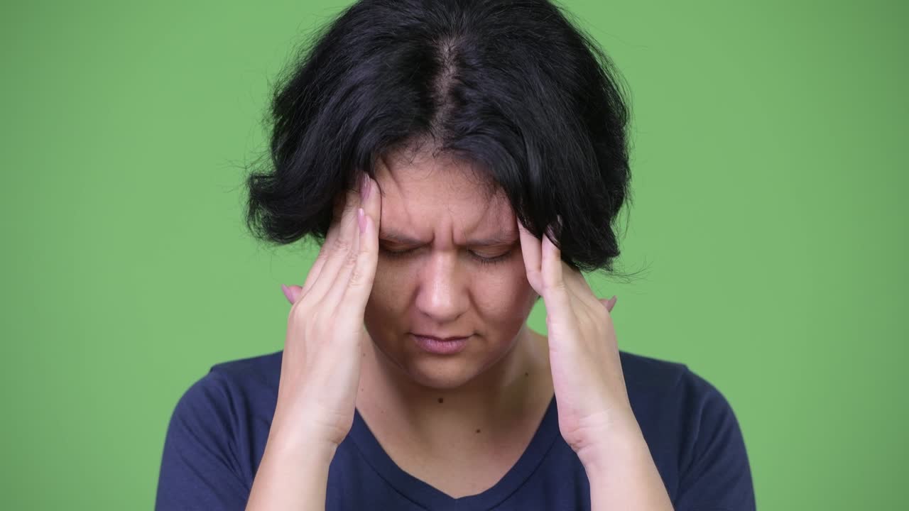 Stressed woman with short hair having headache