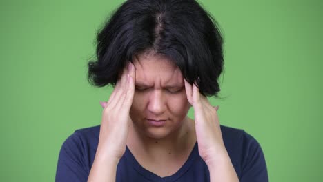 stressed woman with short hair having headache