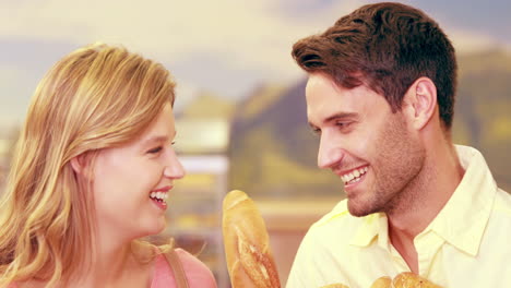 Young-happy-couple-smiling-at-camera-with-bought-goods