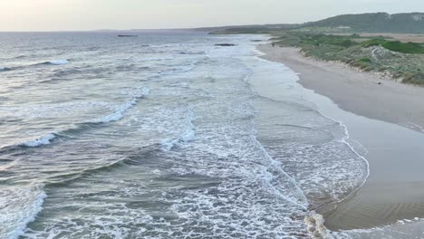 drone flying over waves on spanish coastline