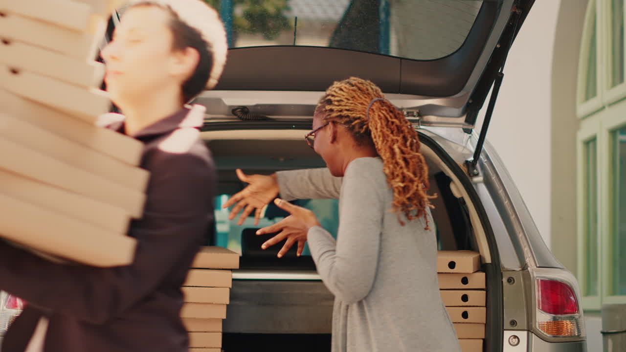 Delivering pizzas from a car trunk