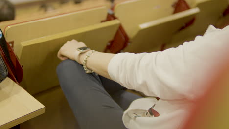 Closeup-shot-of-Caucasian-lady-wearing-hand-jewelry-and-sitting-in-classroom