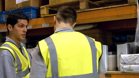 coworkers having discussion in warehouse