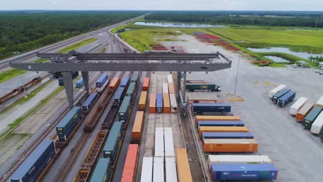 4k drone video of trains and trucks at csx intermodal train yard in winter haven, fl