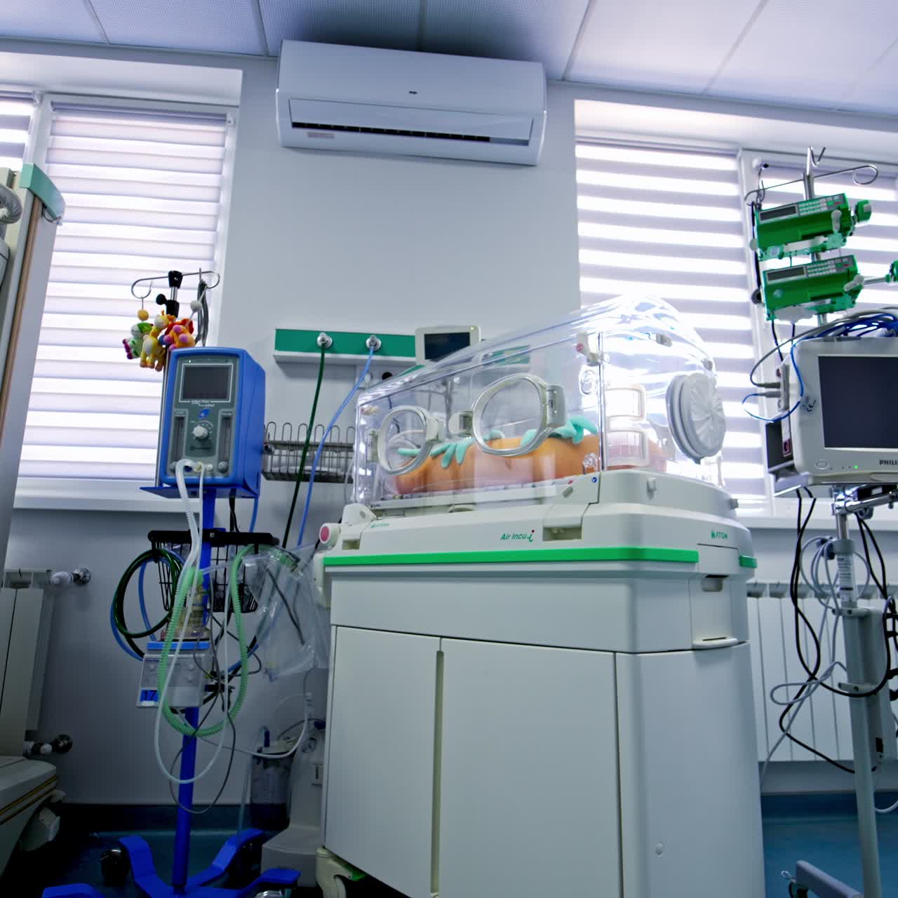Modern advanced equipment for saving lives of babies at maternity hospital. Diverse apparatuses and incubator bed for newborns with birth pathologies in resuscitation room. Low angle view
