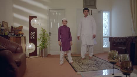 dad and his son come back from mosque on eid holidays