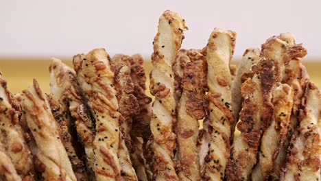 many bread cheese sticks on display in a bakery