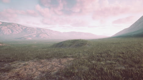 a scenic view of a mountain valley at sunset