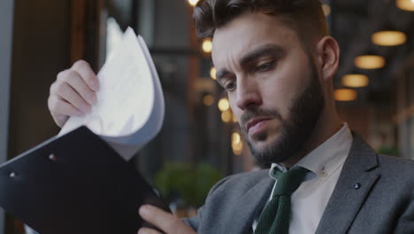 businessman reviewing documents in a cafe