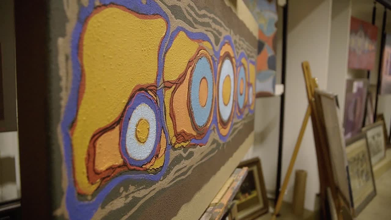 Abstract painting close up, rotating around the artwork inside the gallery of the painter.