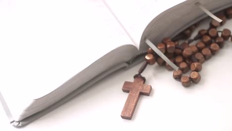 praying to god with bible and cross on a table with white background stock video