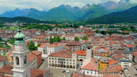 watch as the drone captures the lush valleys and winding rivers that surround belluno, showcasing the harmonious blend of nature and urban life.