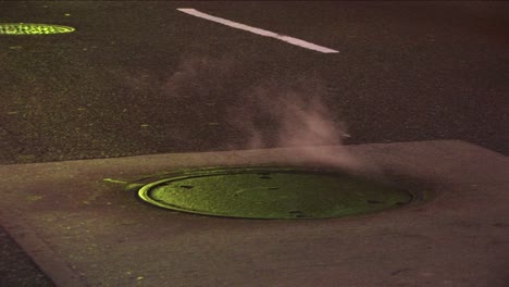 Mediumshot-Of-Steam-Rising-From-A-Manhole-Cover