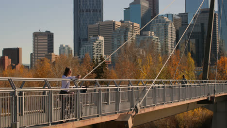 side view of young caucasian man having coffee on the bridge in the city 4k