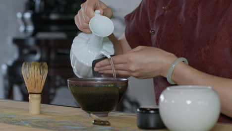 person preparing the traditional chinese tea ceremony