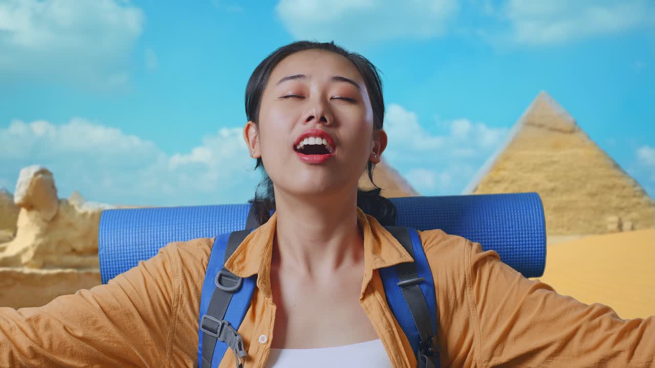 Close Up Of Asian Female Hiker With Mountaineering Backpack Smiling And Spreading Arms Enjoy Looking The View Around While Traveling In Pyramid Of Giza