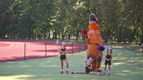 children with dinosaur. children playing with dinosaur costume on stadium