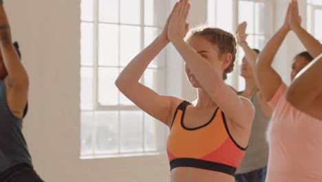 yoga class beautiful caucasian woman practicing warrior pose enjoying fitness lifestyle multi ethnic group of people exercising in studio at sunrise