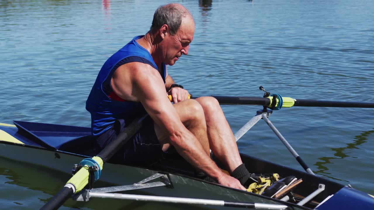 Senior caucasian man preparing rowing boat in a river