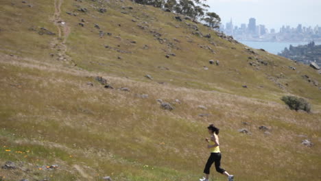 a woman jogs up a hill