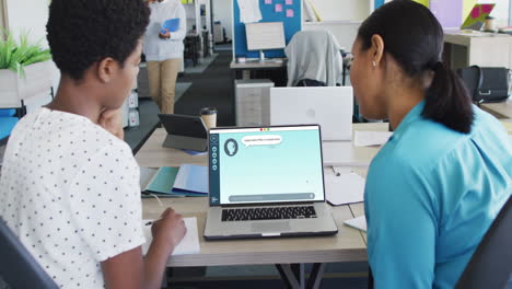 composition of diverse women using laptop with ai chat on screen