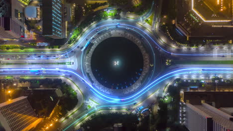 Aerial-hyperlapse-shot-of-traffic-in-a-city-Roundabout,-with-light-trails---3d-graphics-animation---top-down-drone-view