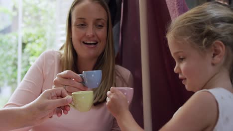 mother and daughters playing dinette together