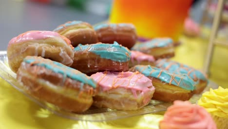 pan of donuts with blue and pink icing