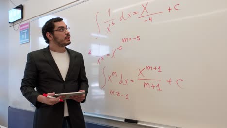 man teaching calculus in a modern lecture hall