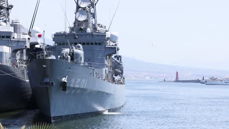 a battleship docked in naples, italy harbor