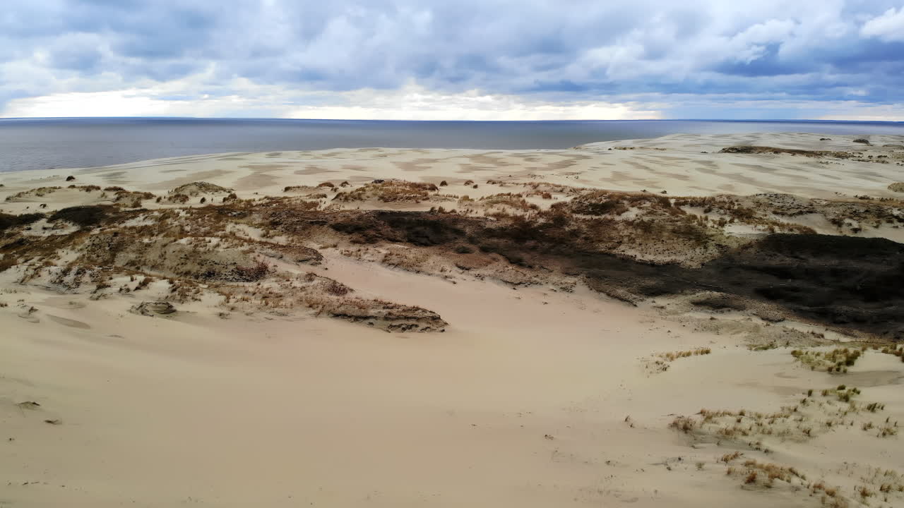 Aerial view of sand dunes and sea