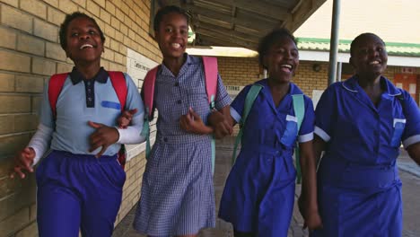 schoolgirls running in the playground at a township school 4k