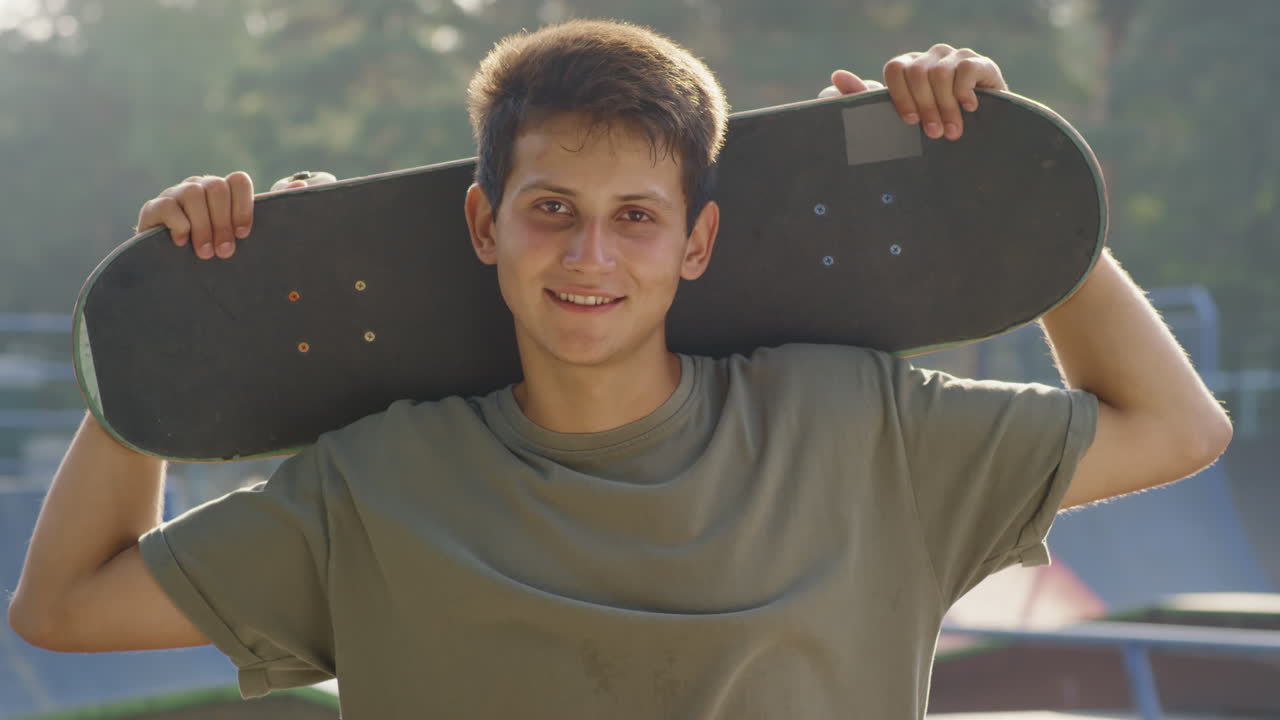 Portrait of Happy Teenager with Skateboard