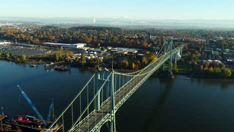 usa, or, portland, st. johns bridge, 2024-11-07 - drone view of the bridge at dawn. the city is st. johns and mt st. helens is visible with snow. mt baker is further away on the right.