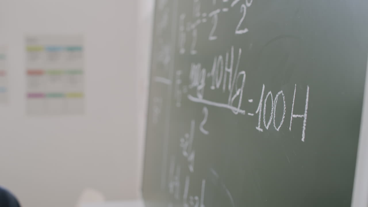 Math Teacher Writing on Chalkboard