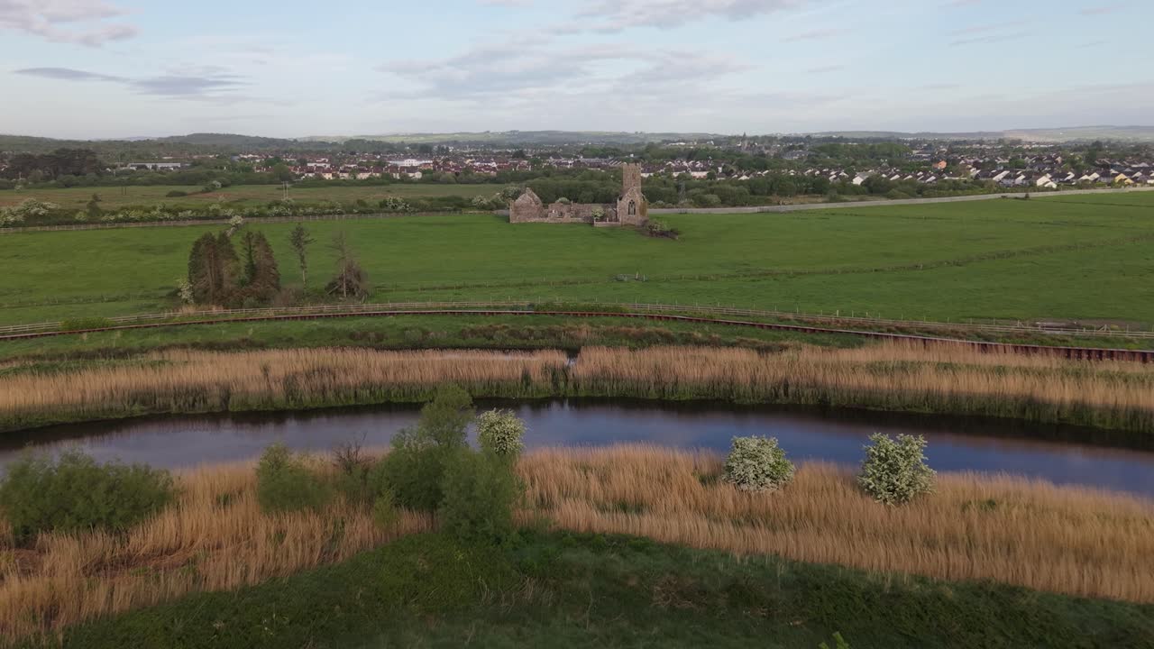 Clare Abbey Ruins From Fergus River In Clarecastle, County Clare, Ireland. - aerial forward shot