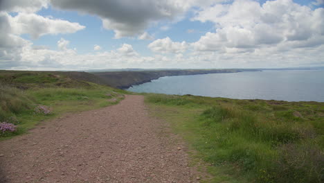 coastal path overlooking calm ocean near st agnes head in cornwall, england, uk