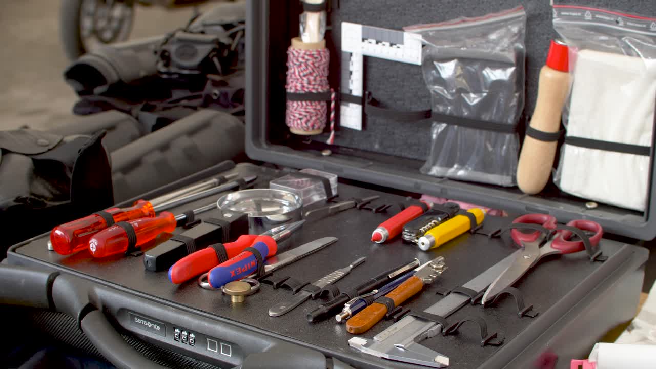 Close up of police equipment case, camera, clothes and other equipment for investigating crimes and crime scenes.