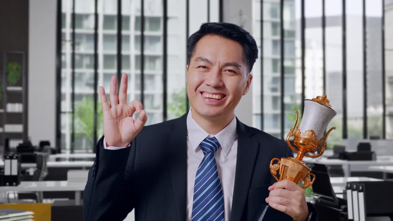 Businessman Celebrating Success with Trophy