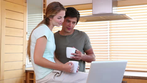 a couple using a laptop together