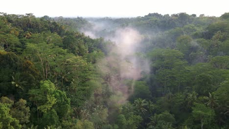 wispy clouds over tropical rainforest near batur mountain in bali, indonesia